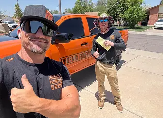 Phoenix Roofing team member with award